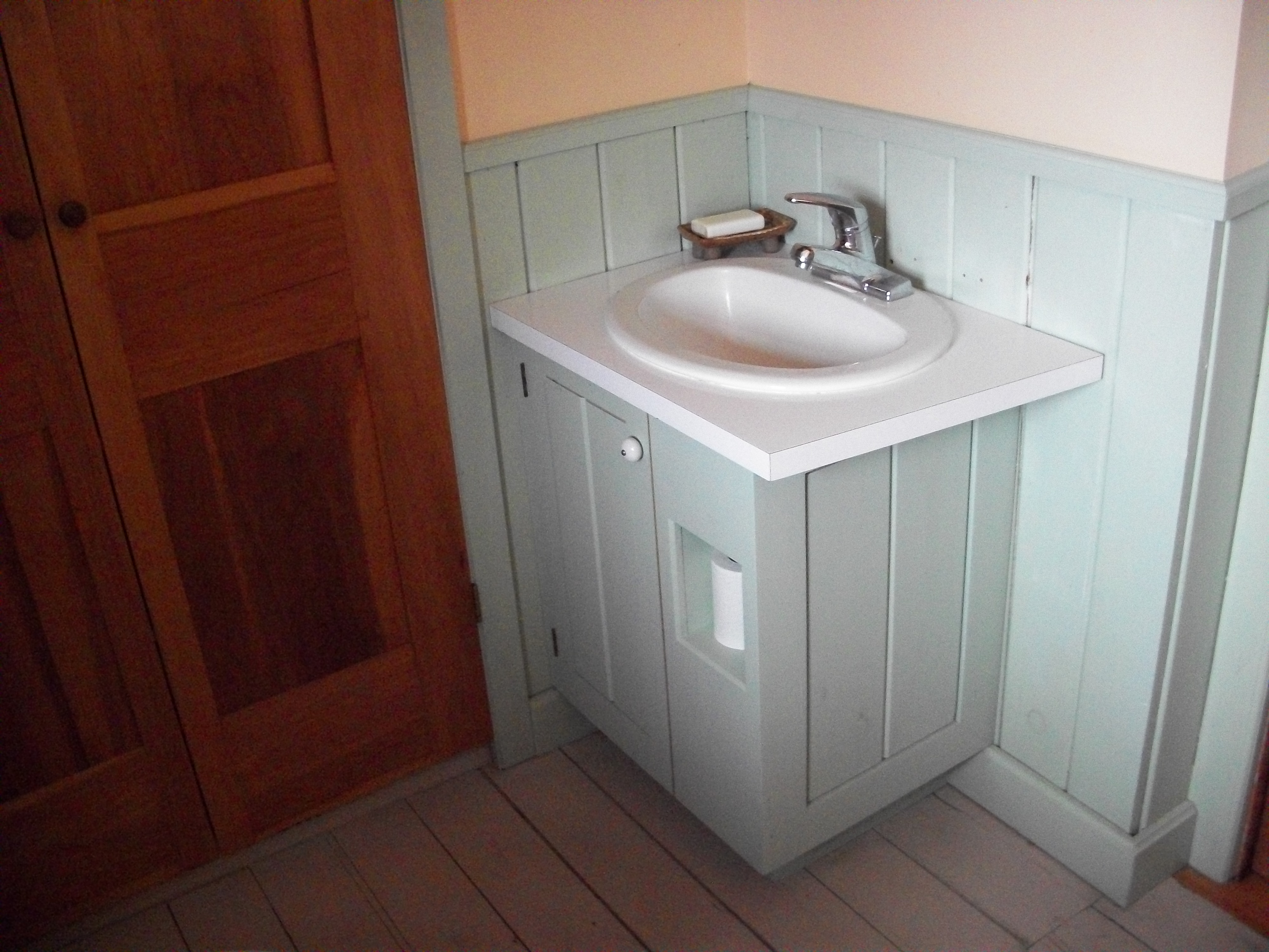 painted-bathroom-corner-vanity-with-cubby
